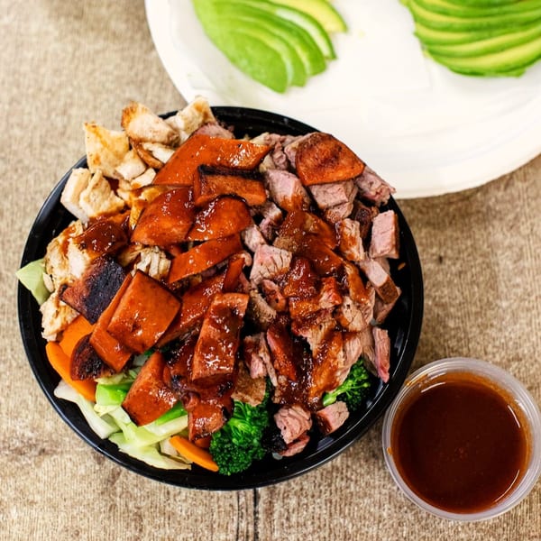 Best BBQ bowl with chicken, beef, pork, vegetables, and a side of sauce.