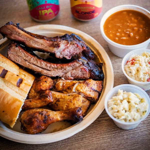 Best BBQ ribs, chicken, bread, baked beans, and potato salad with two beer cans.