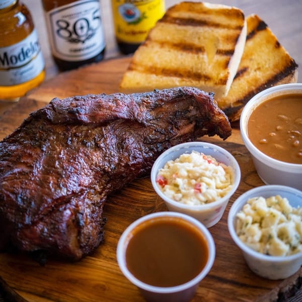 BBQ tri-tip, grilled toast, baked beans, potato salad, and coleslaw with two beers.